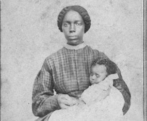 Ethnic: Full-length portrait of an African American woman seated holding an African American infant